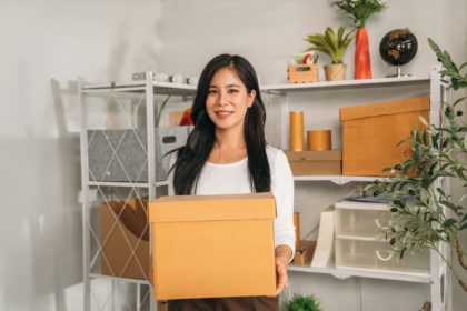 Asia young woman Store things in shelves at her home.