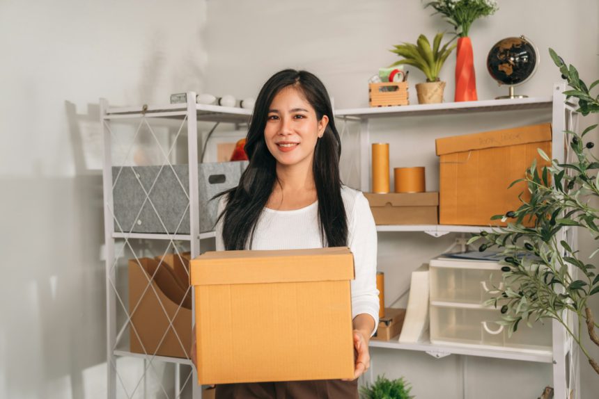 Asia young woman Store things in shelves at her home.