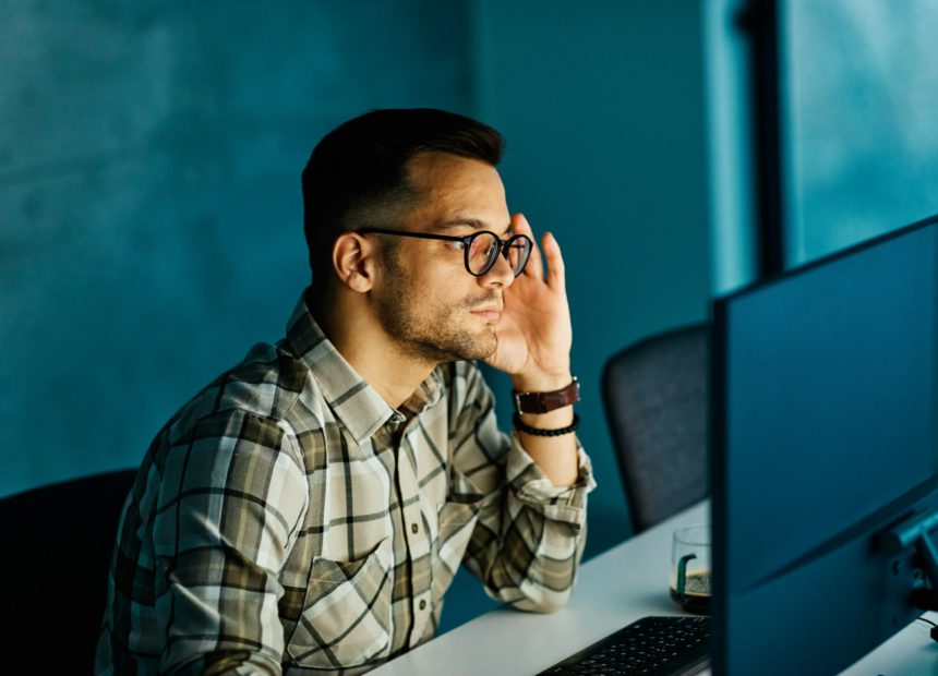 businessman working late night business computer man office technology light dark young internet