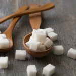 close up of three different types of sugar, white refined granulated sugar, brown cane sugar and sug
