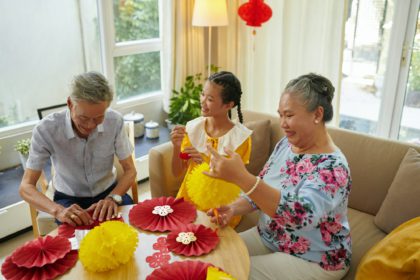 Girl Making Garland with Grandparents