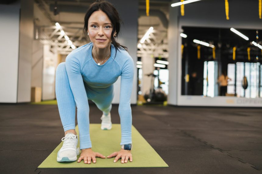 Woman doing stretching in the gym. Pilates exercise